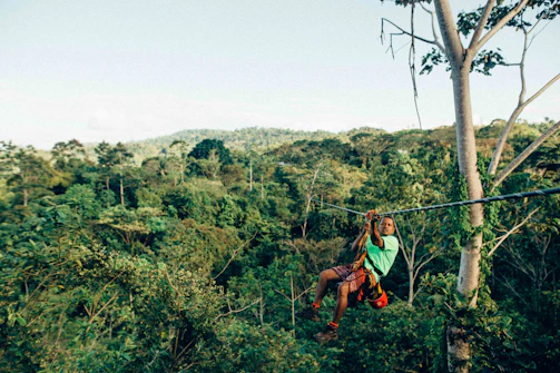person sliding on zip line