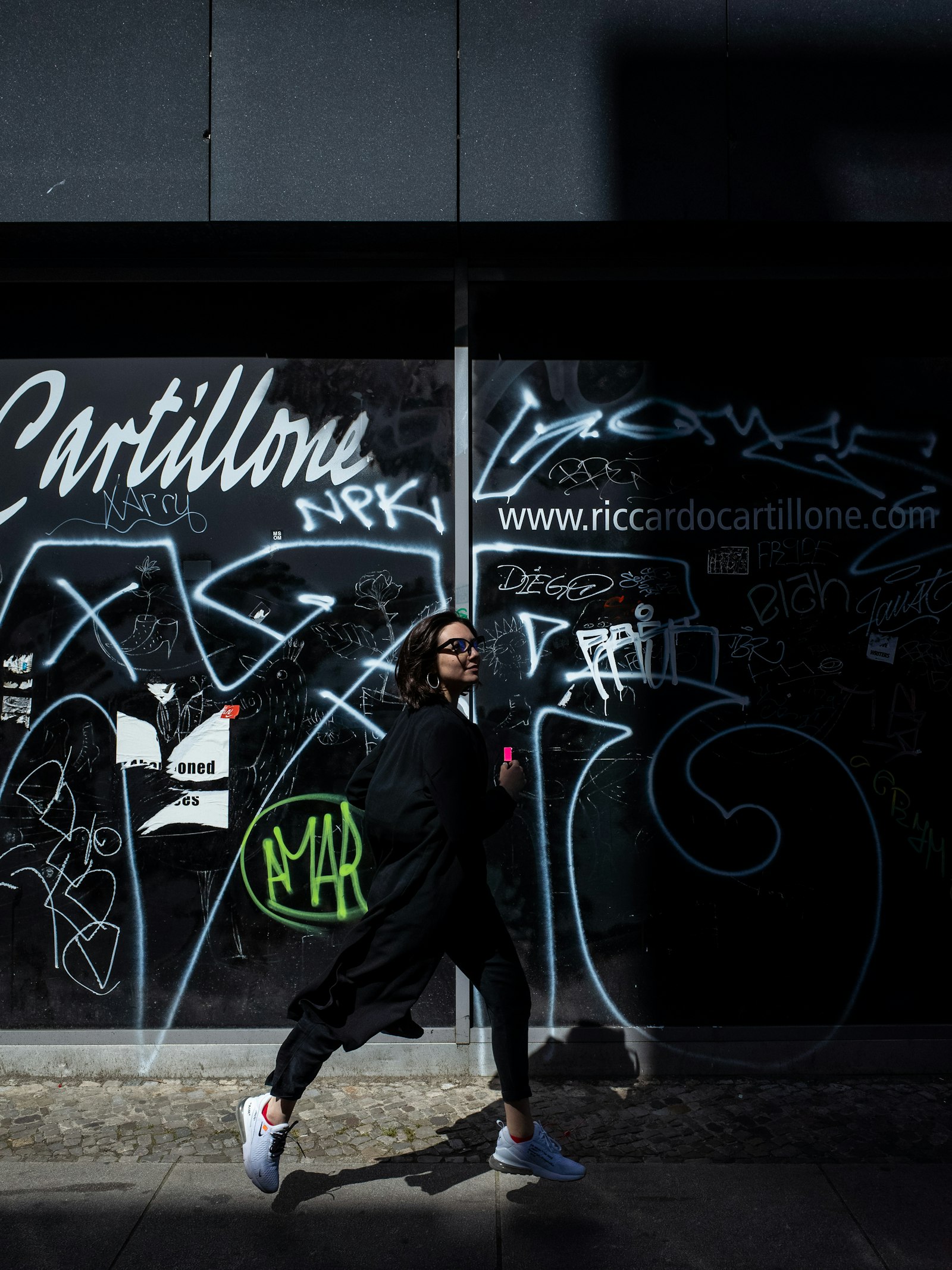 Ricoh GR II sample photo. Woman walking beside graffiti photography