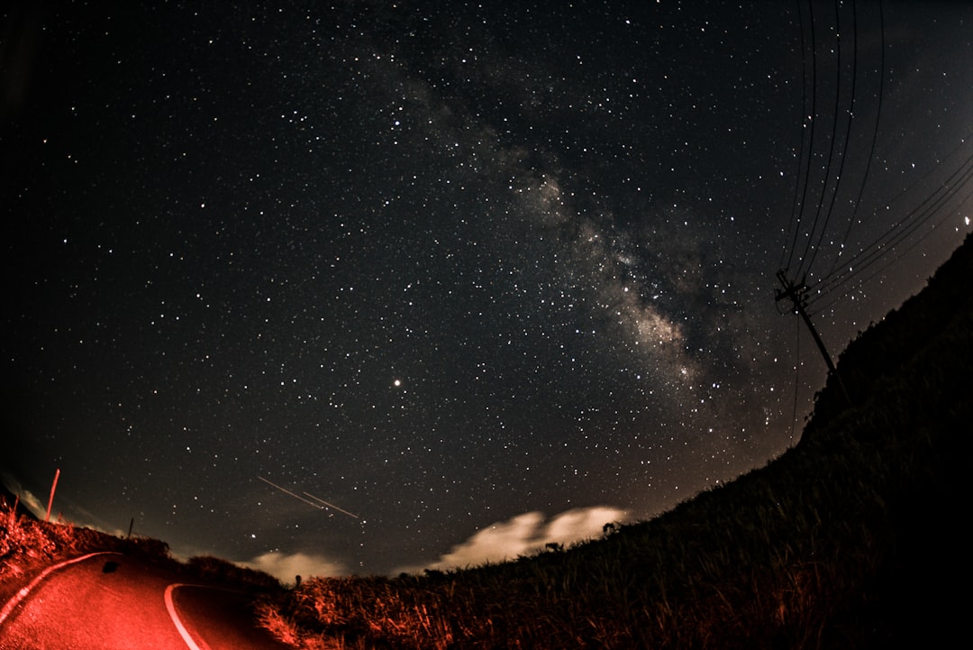 red lighted road under starry sky