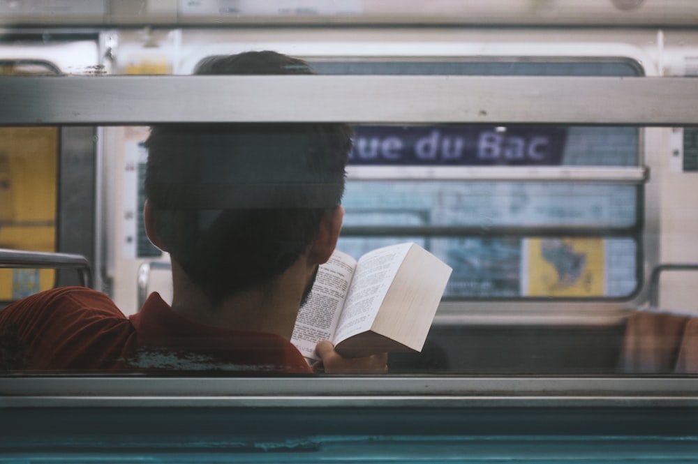 man reading inside train
