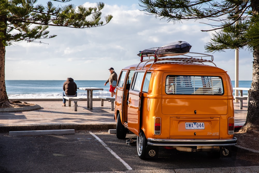 orange van park beside tree