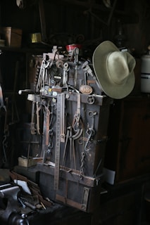 A collection of vintage plumbing tools arranged on a wooden workbench.
