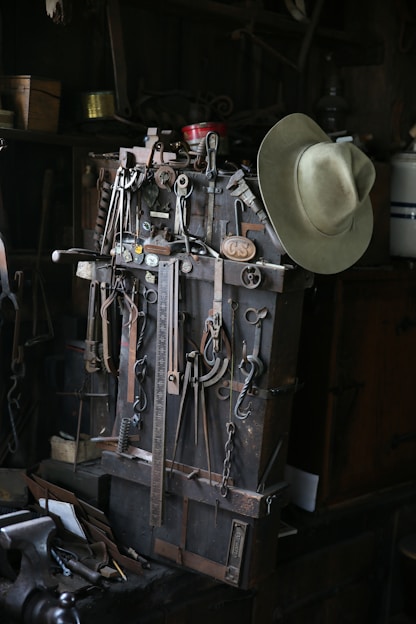 A collection of rugged tools displayed on a steel workbench.