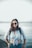 woman in blue crop-top standing beside body of water