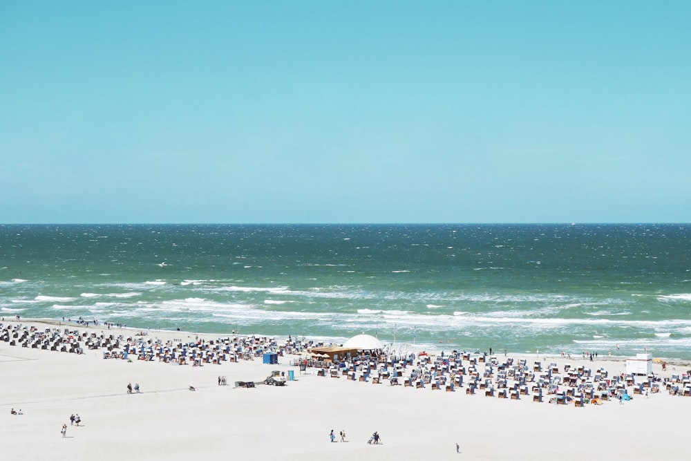 aerial view of people on sand near sea