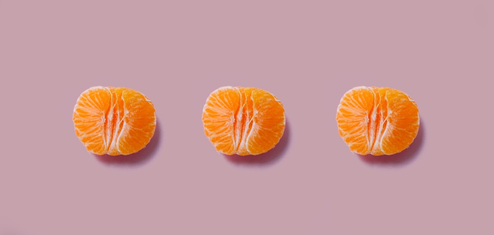 three orange fruits