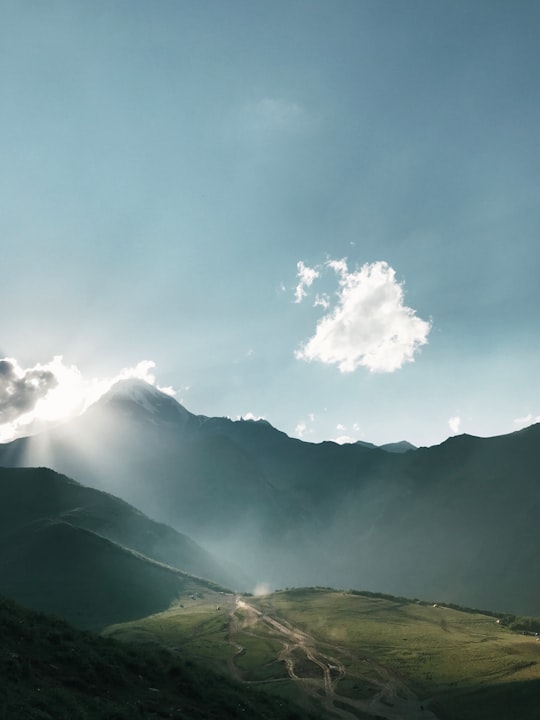 mountain under clear blue sky in გერგეტის სამება Georgia