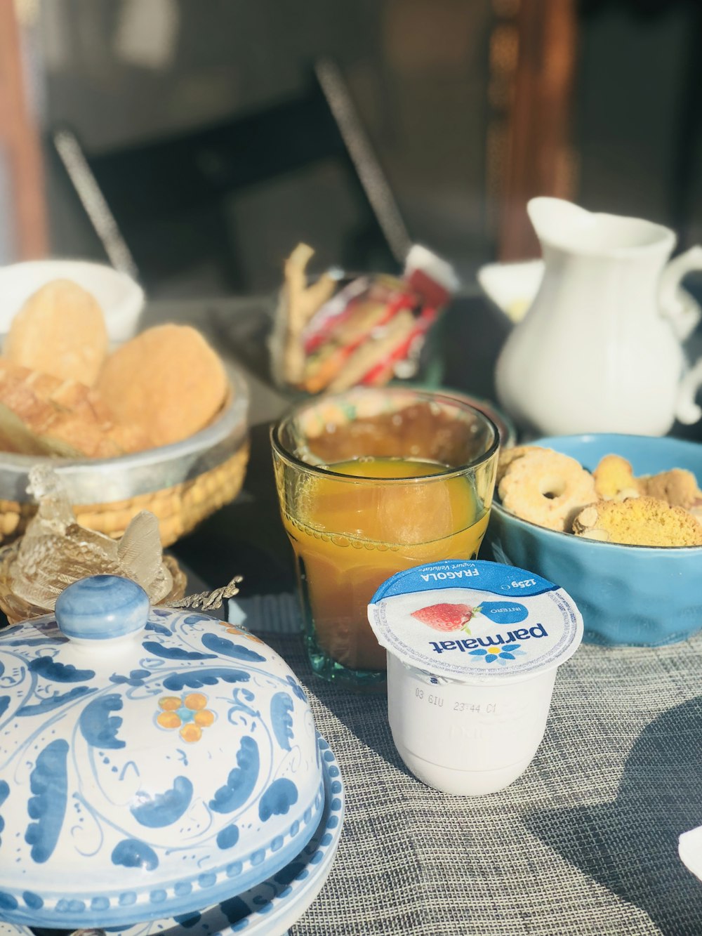 biscoitos perto de suco de laranja e recipiente Parmalat