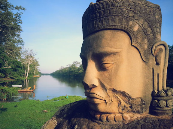 A serene riverside scene with an ancient book of Shrimad Bhagwat Geeta resting on a stone.