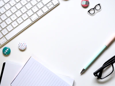 A minimalist desk with a neatly arranged notebook and pen beside a muted blue folder, symbolizing precise messaging.