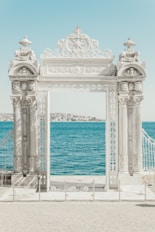 gray pillars near body of water