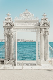 gray pillars near body of water