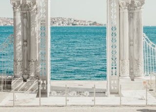 gray pillars near body of water