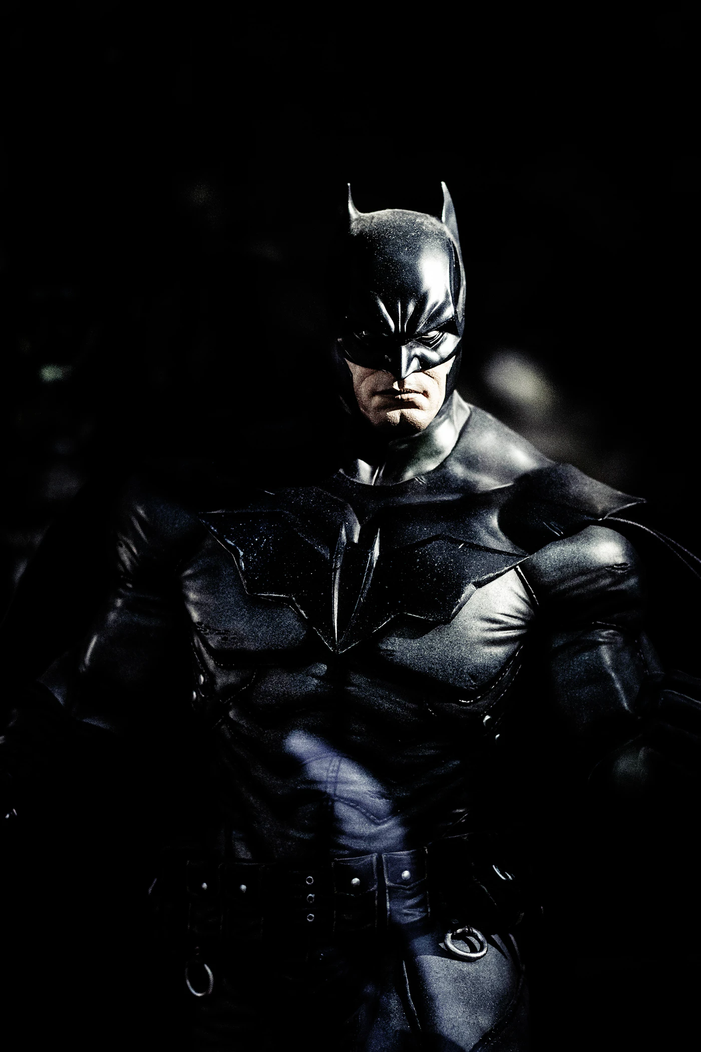 Person in a dark cowl and cape, photographed as costume reference
