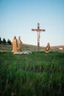 Crucifix statue on green grass