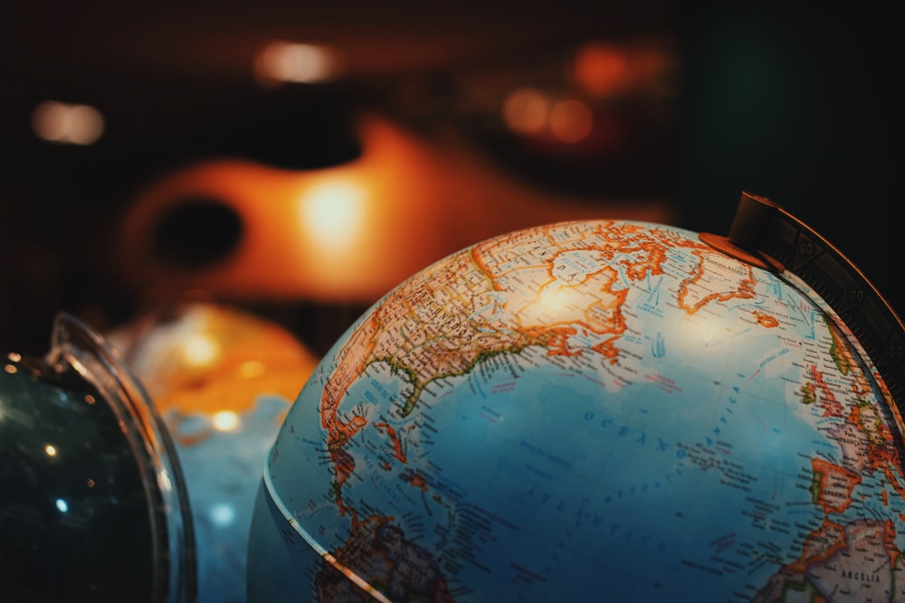 selective focus photo of terrestrial desk globe