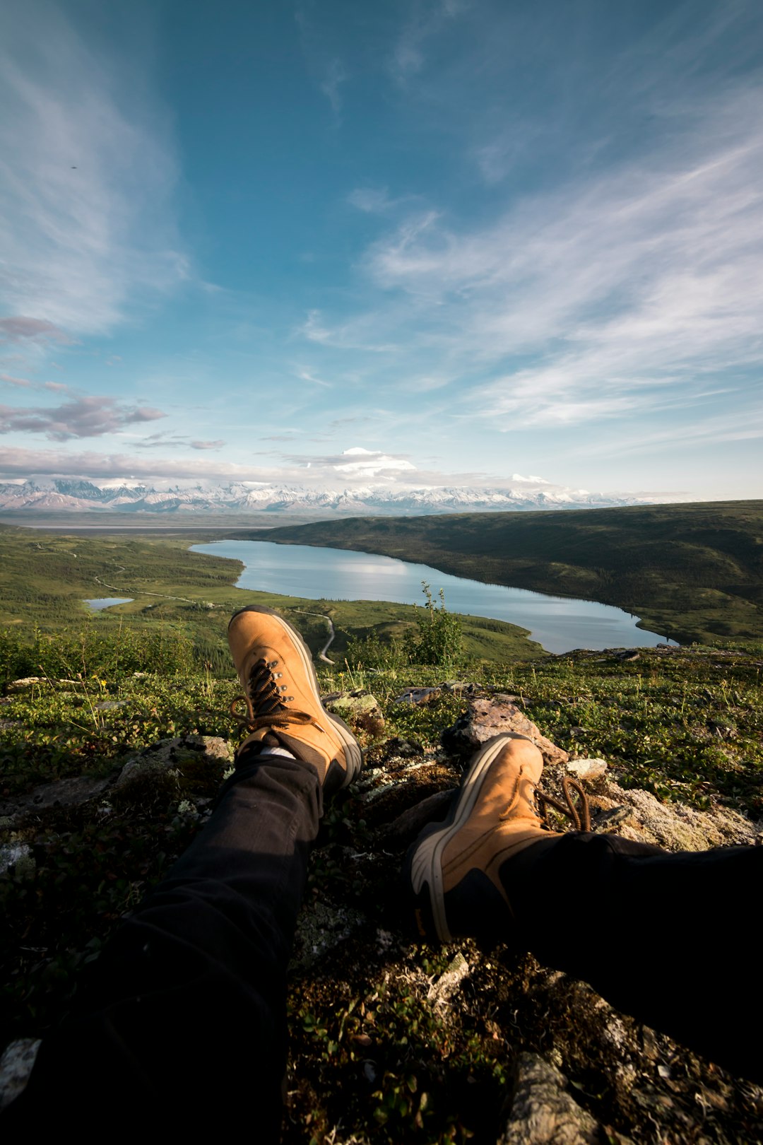 person sitting front of river at daytime