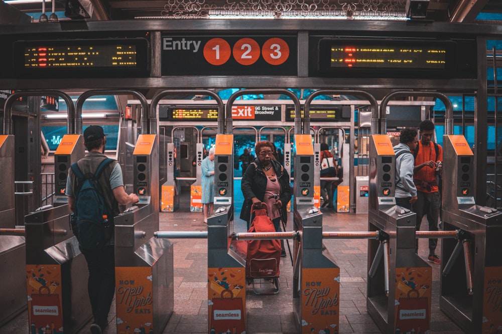 woman pulling red stroller at the train station