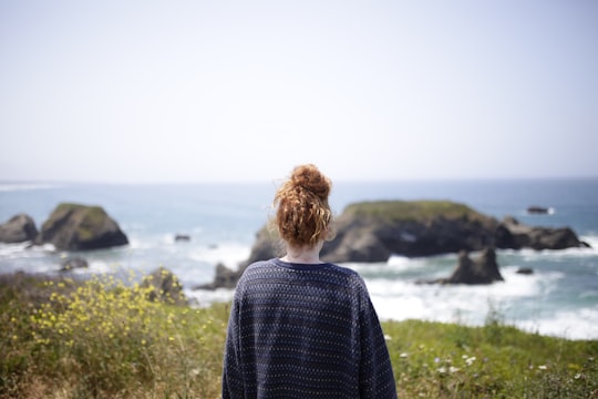 woman looking at body of water in Fort Bragg United States