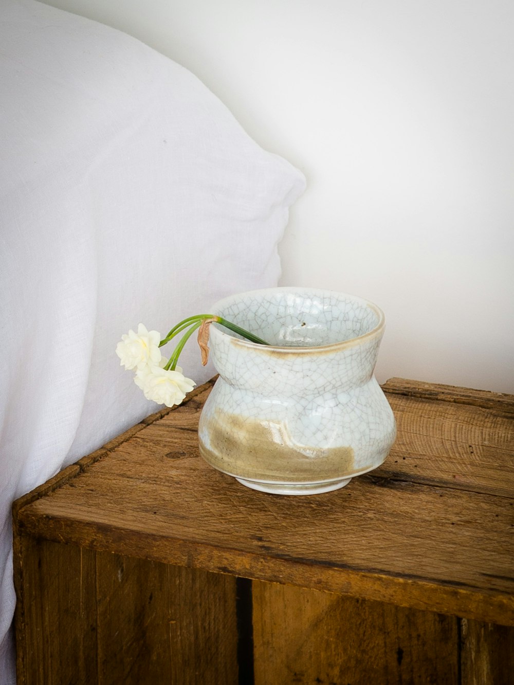 photo of white vase with flowers