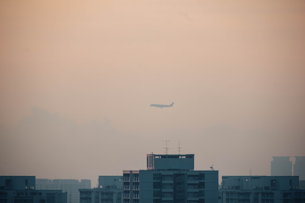 airplane flying over buildings