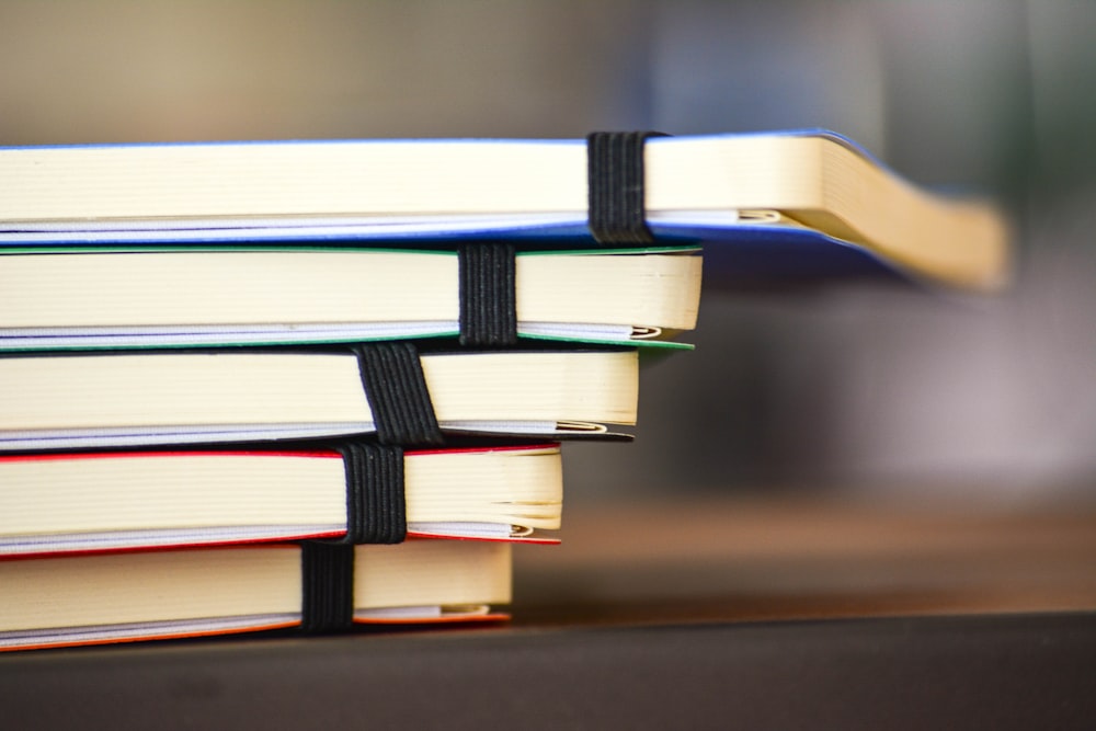 shallow focus photography of stack of book