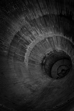 a black and white photo of a spiral staircase
