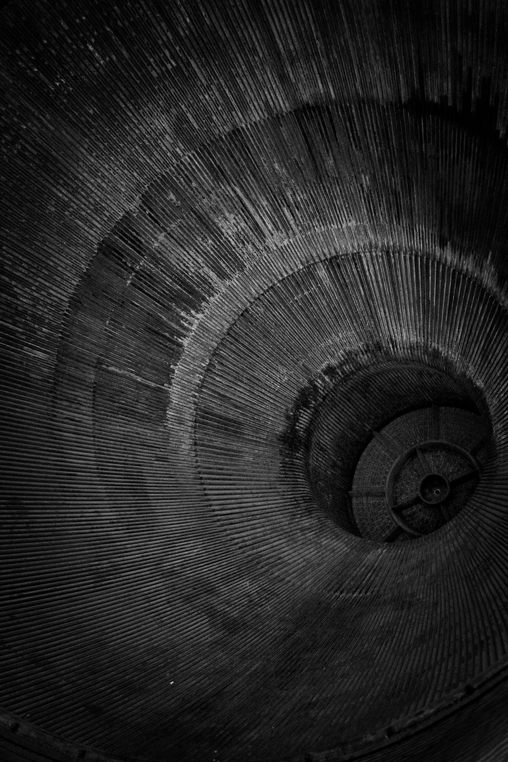 a black and white photo of a spiral staircase