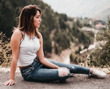 woman in white tank top sitting on soil