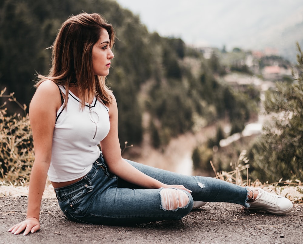 woman in white tank top sitting on soil