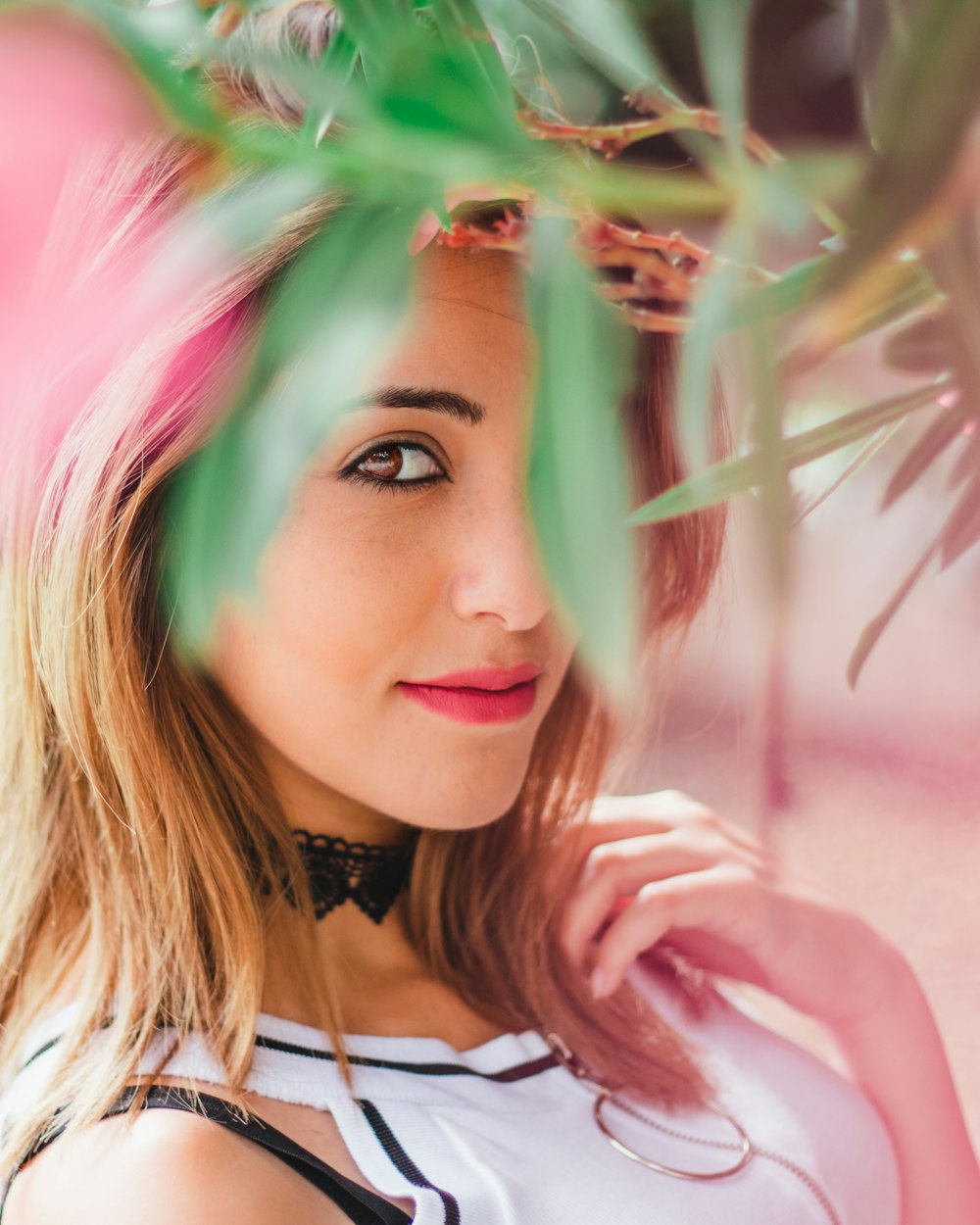 woman posing near green plant