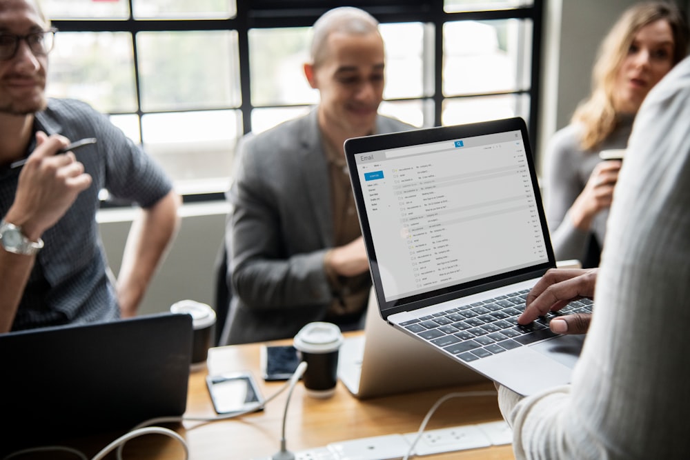 group of people having meeting using laptop computers