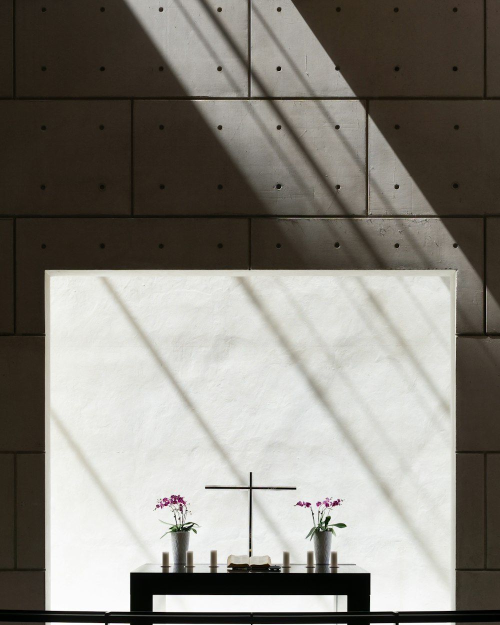 purple flowers iin vases on black wooden table