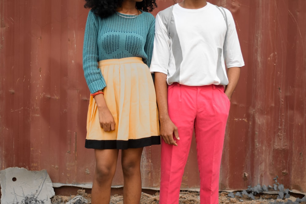 man and woman standing against wall