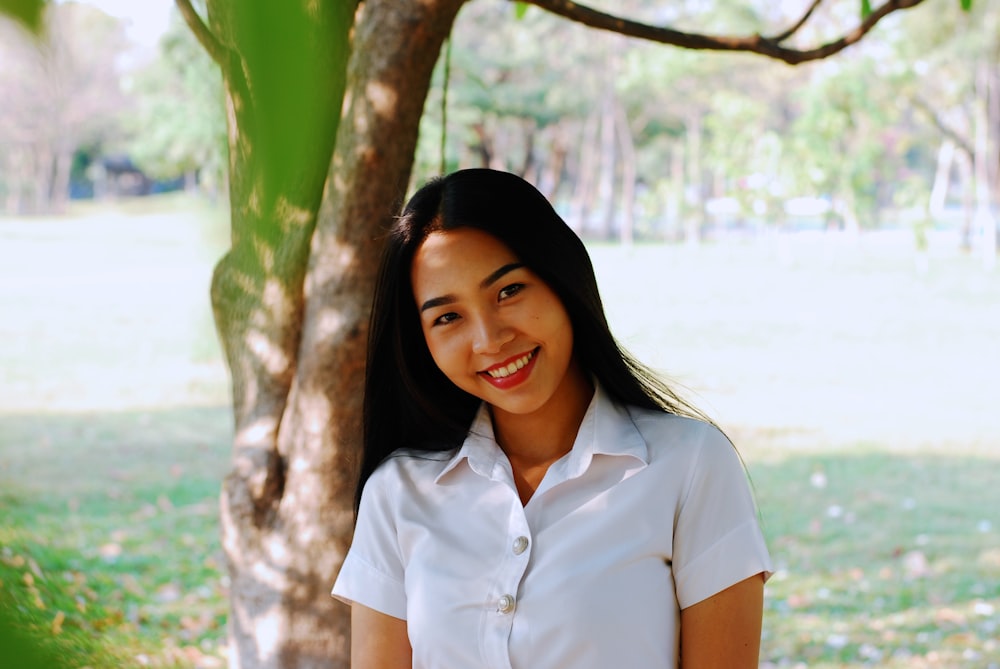 woman standing beside tree