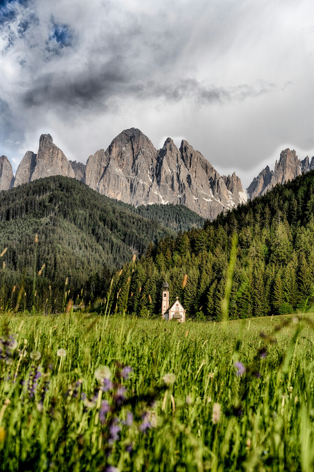 landscape photograph of church near mountain ranges