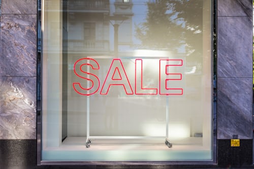 Sale sign on a glass window display to represent sale of TikTok followers.