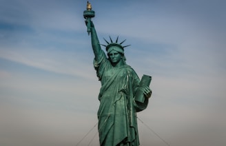 A close-up of the Statue of Liberty taken from a sightseeing boat on a sunny day.