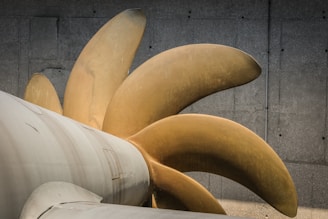 Image showing medium-sized aluminum balancing clips next to a turbine blade.