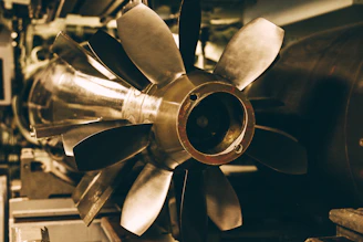 Close-up of a powerful industrial turbine blade gleaming under workshop lights