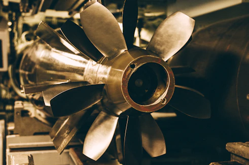 Close-up of a powerful industrial turbine blade gleaming under workshop lights