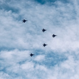 A professional team coordinating aircraft procurement with digital devices.