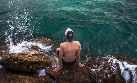 man on top of rock formation in Oran Algeria