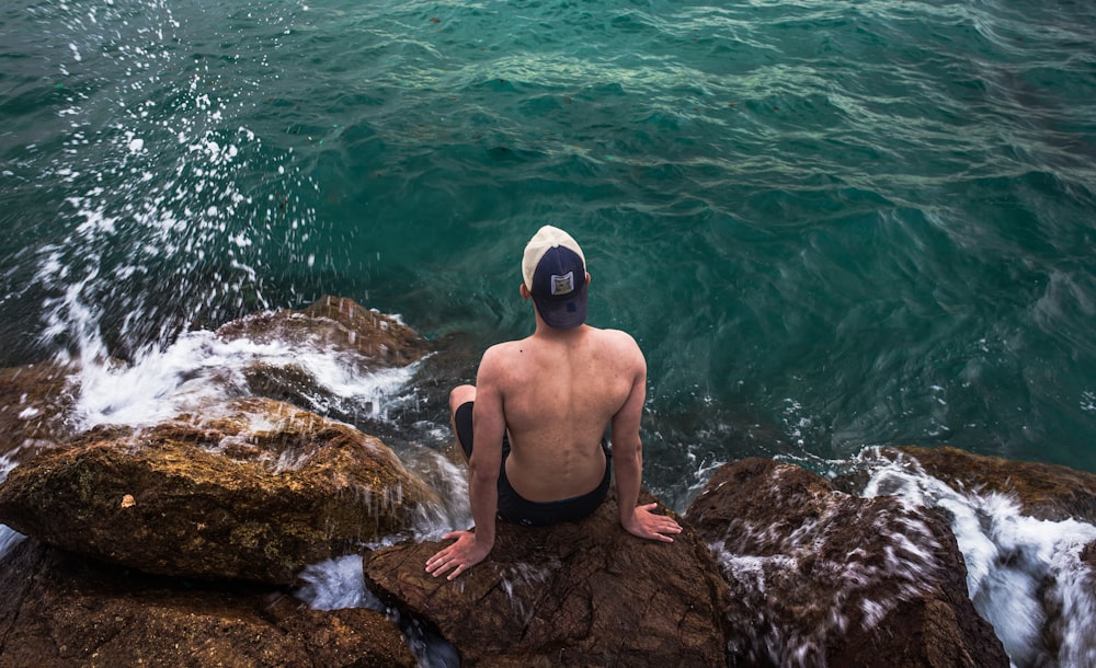 man on top of rock formation