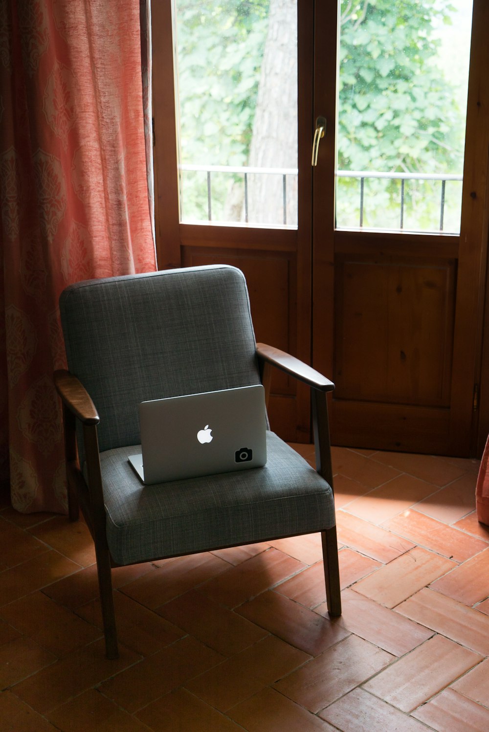 silver MacBook on chair