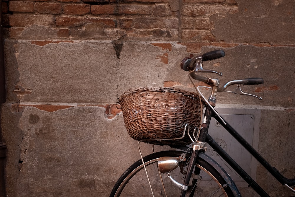 black and grey cruiser bicycle leaning on wall