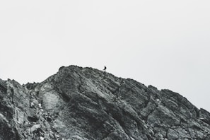 person walking on rock mountain