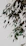Close-up of a luxurious canvas painting featuring lush green forest leaves with soft gold accents.