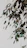 Close-up of a luxurious canvas painting featuring lush green forest leaves with soft gold accents.