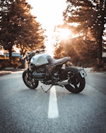 white and black BMW cruiser motorcycle in the center of road